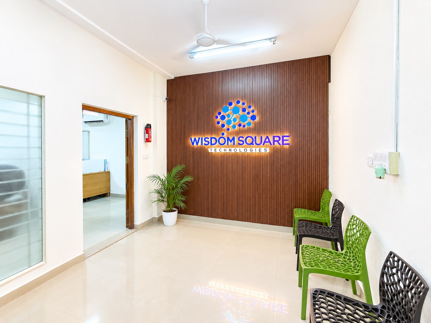 Reception desk and branded wall at the Wisdom Square Technologies office.