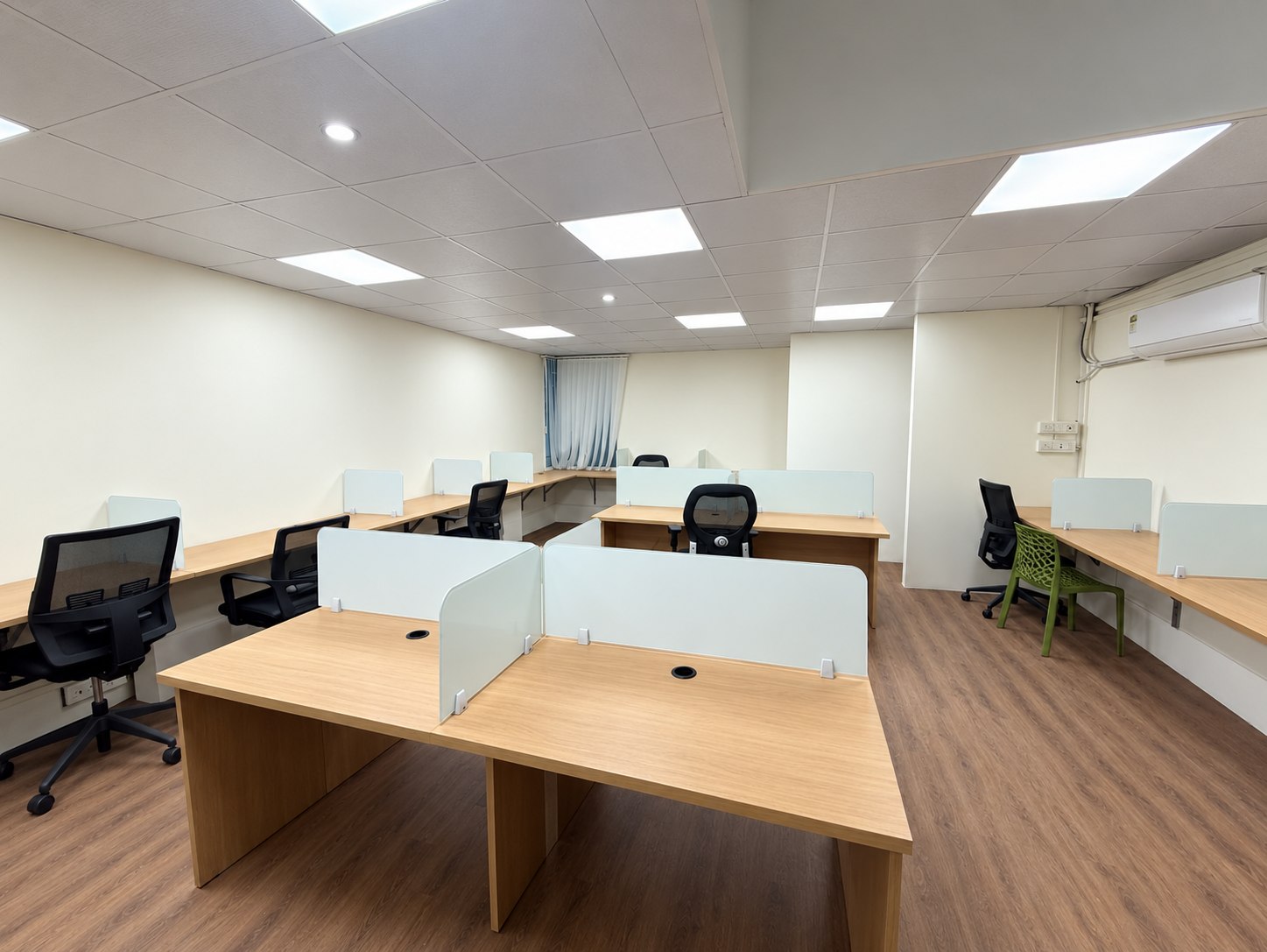 Shared work area with dedicated desks at the Wisdom Square Technologies office.